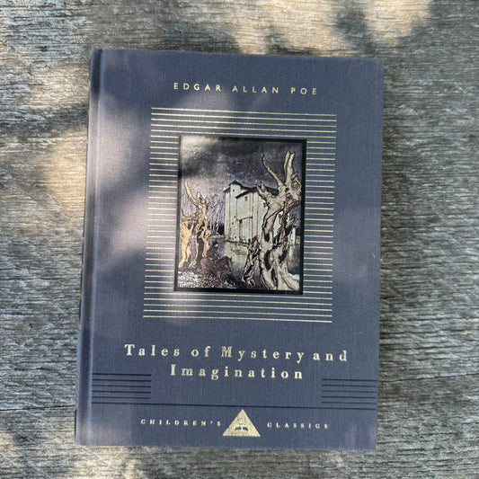Book titled 'Tales of Mystery and Imagination' by Edgar Allan Poe on a textured surface